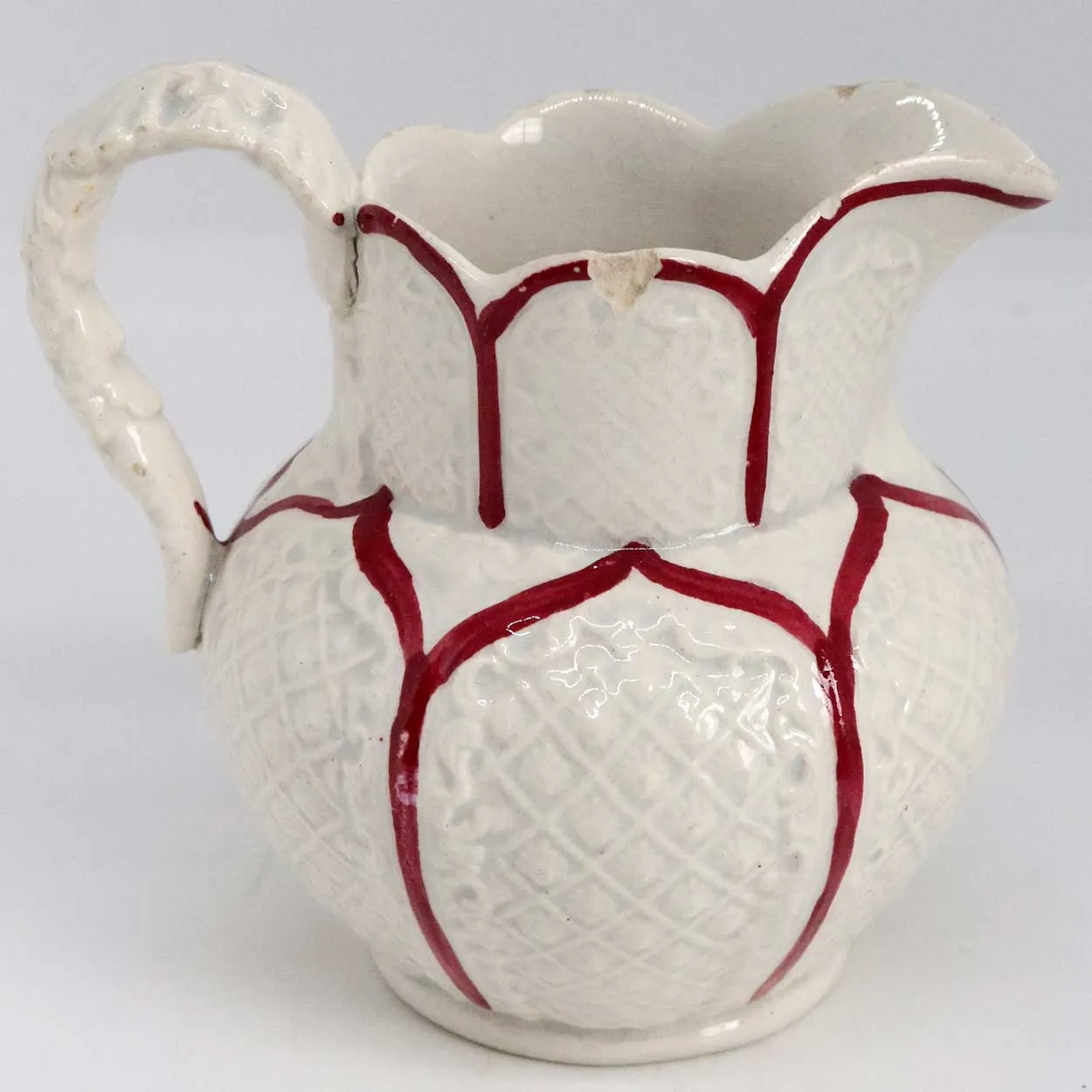Small Moulded Pottery Red and Cream Glazed Creamer Pitcher
