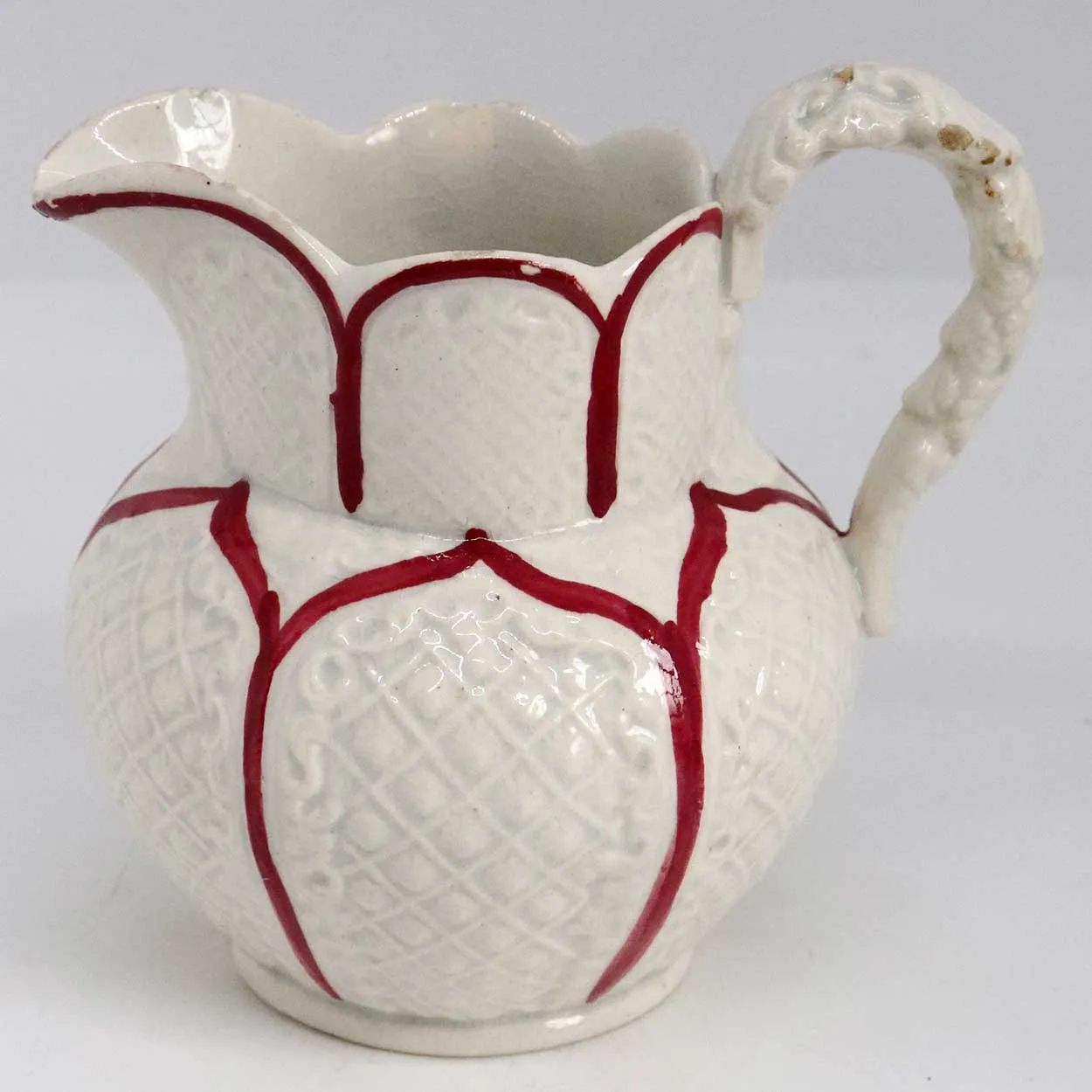 Small Moulded Pottery Red and Cream Glazed Creamer Pitcher